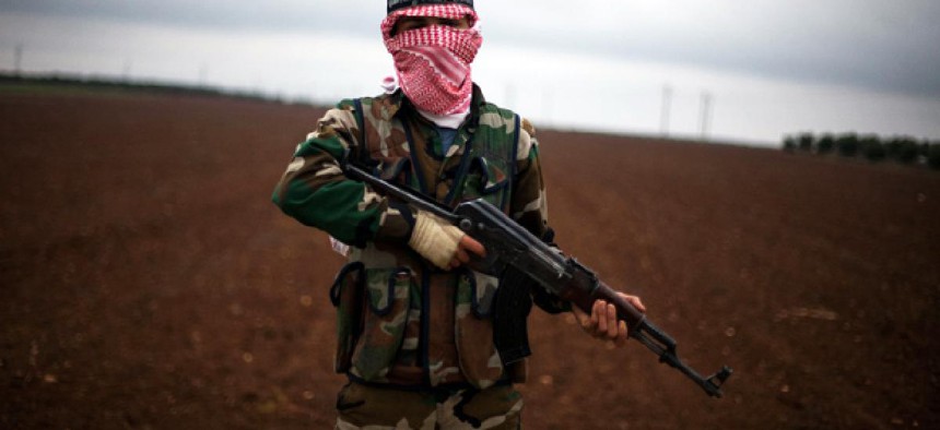 A Free Syrian Army fighter takes position close to a military base, near Azaz, Syria.