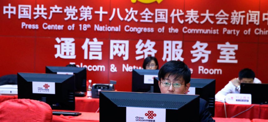A Chinese man uses a computer at the press center of the 18th Communist Party Congress in Beijing, China. 