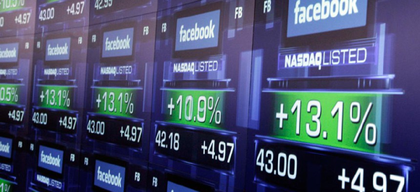 Electronic screens show the price of Facebook shares after they began trading Friday, May 18, 2012 in New York.