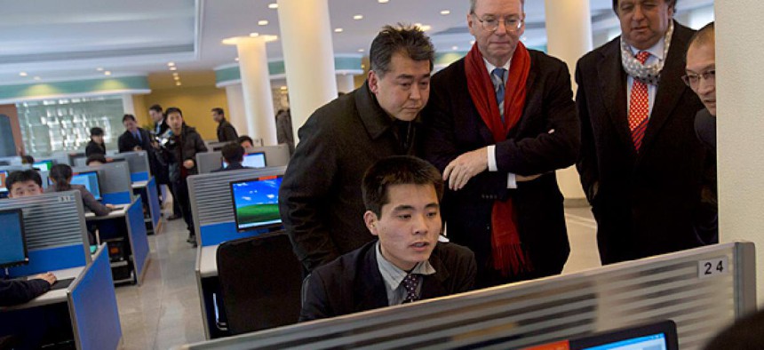 Executive Chairman of Google, Eric Schmidt, third from left, and former New Mexico governor Bill Richardson, second from right, watch as a North Korean student surfs the Internet.