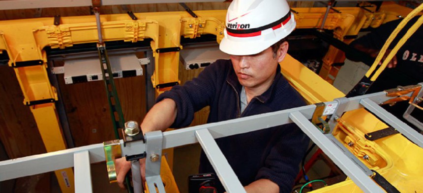 Verizon technician Kevin Pak installs Verizon Fios fiber optic cables during the ongoing hurricane restoration project in Manhattan.