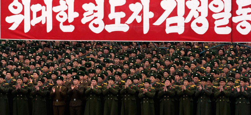 North Korean soldiers applaud during a mass rally organized to celebrate the success of a rocket launch.
