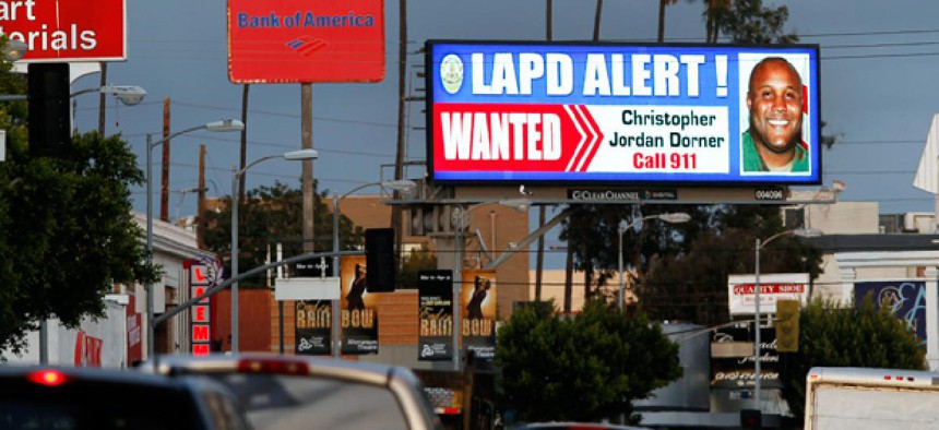 A digital billboard shows a "wanted" alert for former Los Angeles police officer Christopher Dorner.