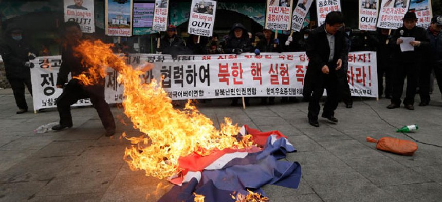 South Korean protesters burn a North Korean flag during an anti-North Korea rally in Seoul Tuesday.