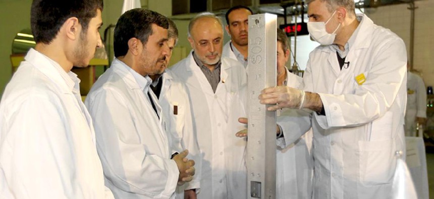  Iranian President Mahmoud Ahmadinejad, second left being escorted by technicians during a tour of Tehran's research reactor center in northern Tehran, Iran.