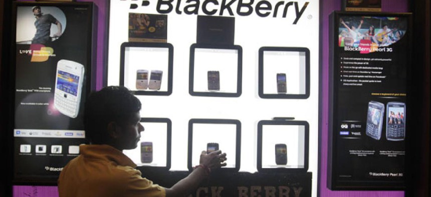 A shopkeeper displays BlackBerry mobile phones in his shop in Ahmadabad, India in 2010.