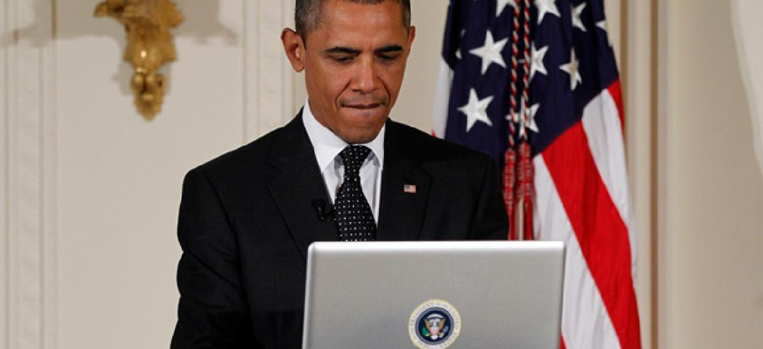 President Barack Obama uses a laptop computer to send a tweet during a "Twitter Town Hall."