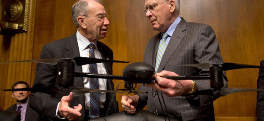 Sen. Patrick Leahy, D-Vt., holds an example of a drone, as he talks with the Sen. Charles Grassley, R-Iowa, Wednesday.