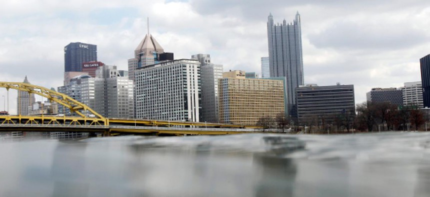 The Pittsburgh skyline rises above the waters of the Ohio River.