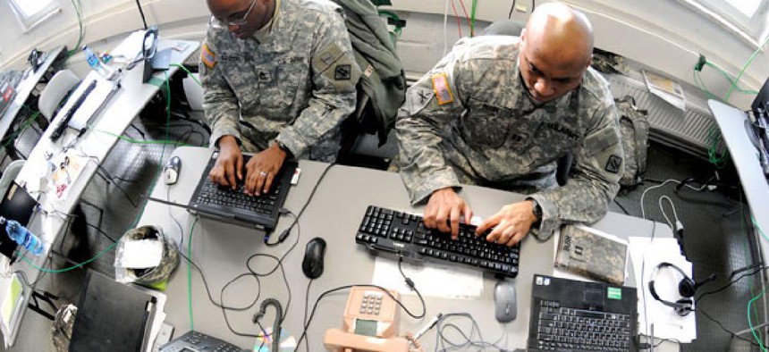 aster Sgt. Charlie Sanders (left) and Capt. Lashon Bush work on a Mission Event Synchronization List in the Joint Cyber Control Center at Grafenwoehr, Germany