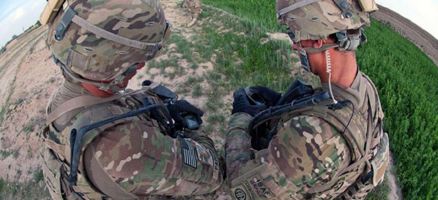 U.S. Army paratroopers compare their wrist units equipped with global positioning during a foot patrol in Afghanistan's southern Ghazni province, May 8, 2012.