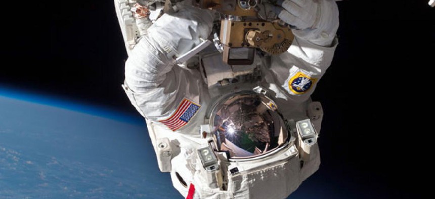Astronaut Chris Cassidy and Tom Marshburn, not pictured, perform a space walk to inspect and replace a pump controller box on the International Space Station on May 11, 2013.