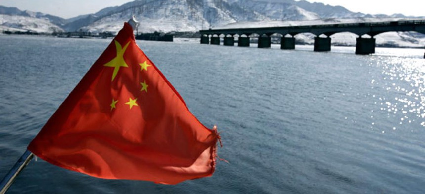 A Chinese flag is hoisted near the Hekou Bridge.