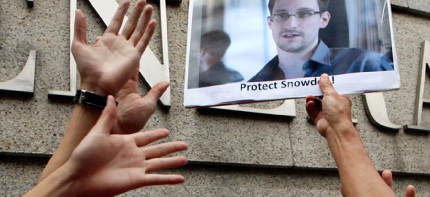 A supporter holds a picture of Edward Snowden, outside the U.S. Consulate General in Hong Kong. 