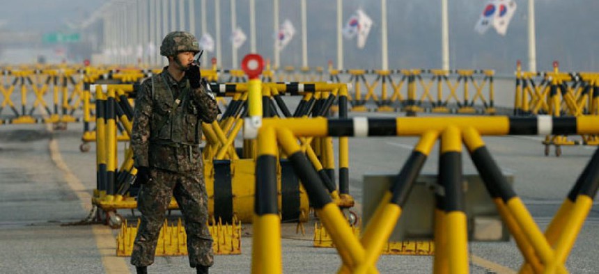 A South Korean soldier uses his radio at Unification Bridge.