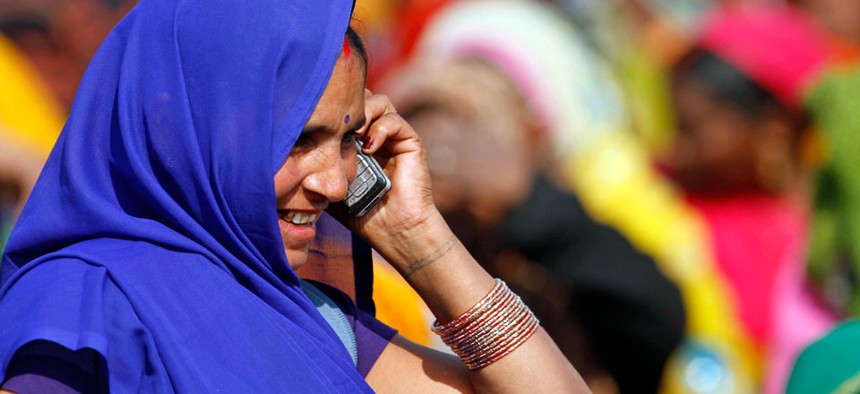An Indian woman talks on her mobile phone at an election rally in Faizabad, India.