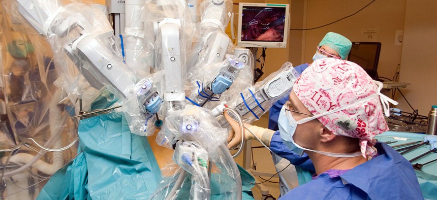 The da Vinci surgical robot system in action during a surgery.