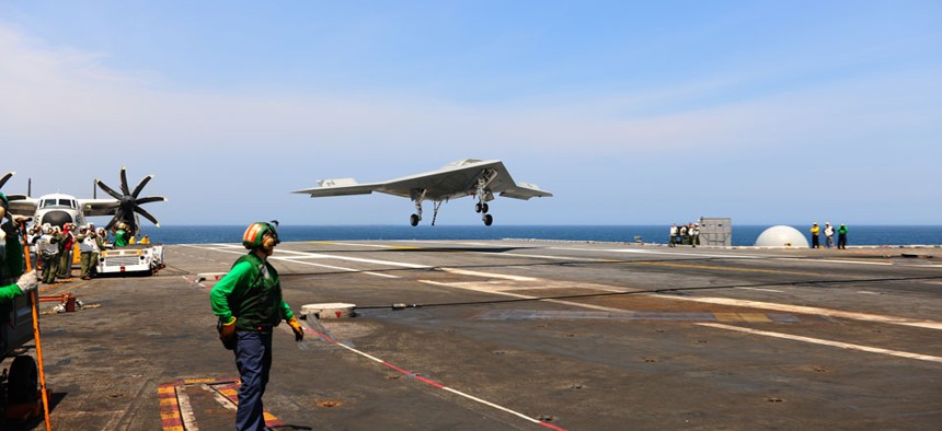 The X-47B lands aboard the USS George H.W. Bush aircraft carrier off the coast of Virginia.
