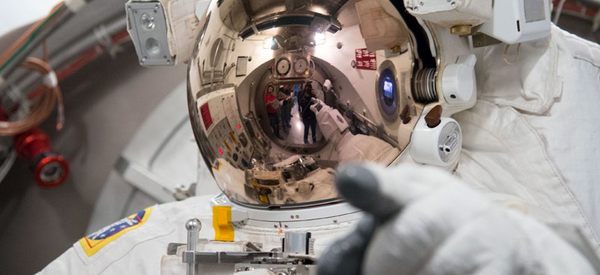 European Space Agency astronaut Luca Parmitano tests his spacesuit NASA's Johnson Space Center.