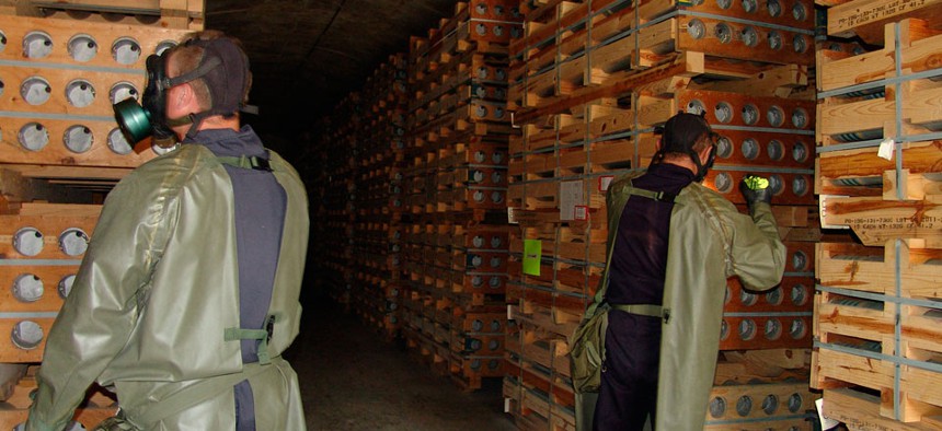 Workers inspect chemical agent munitions stored at the Blue Grass Army Depot in Kentucky. The Pentagon is seeking more than $700 million in fiscal 2014 funding for the agency assigned to destroy chemical stockpiles at Blue Grass.