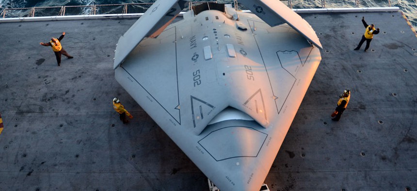 Sailors moving an X-47B Unmanned Combat Air System, which was the first unmanned craft to catapult launch from an aircraft carrier. 