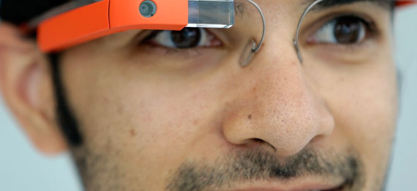 Google Glass team member Salil Pandit wears Google Glasses at a booth at Google I/O 2013.