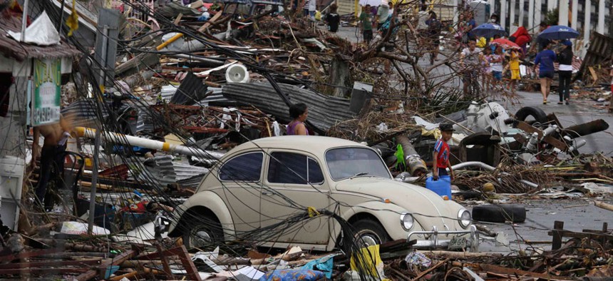 People search through debris in the Leyte province Tuesday.