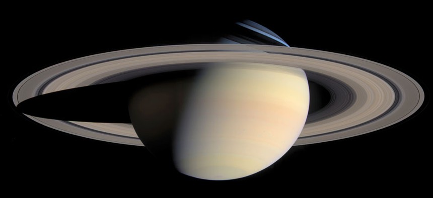 A photo taken by the Cassini Saturn Probe shows the planet Saturn and its rings.