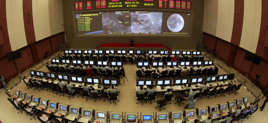 Researchers work in the control room of the Chang'e 3 lunar probe at the Beijing Aerospace Control Center,.