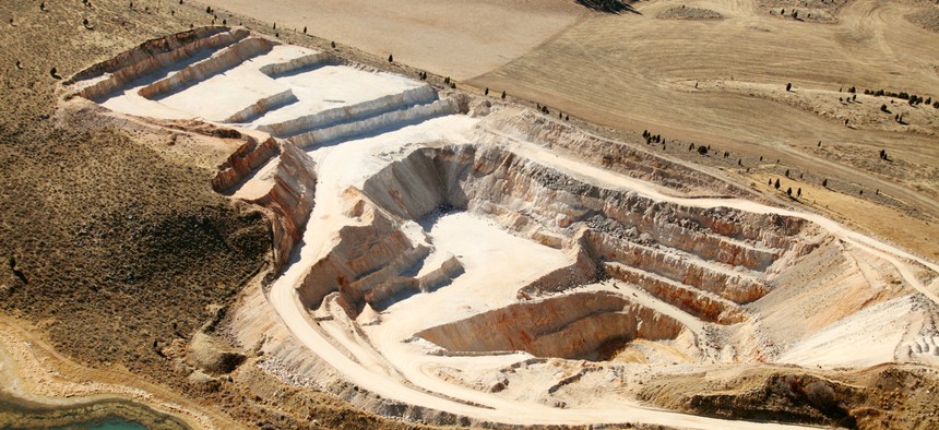An aerial view of an open pit phosphate mine.