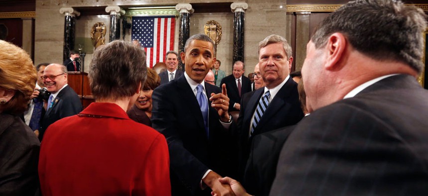 President Barack Obama shakes hands as he leaves after giving the State of Union address.