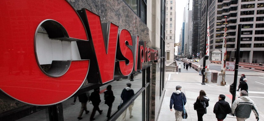 Pedestrians walk pass a CVS store in Chicago.