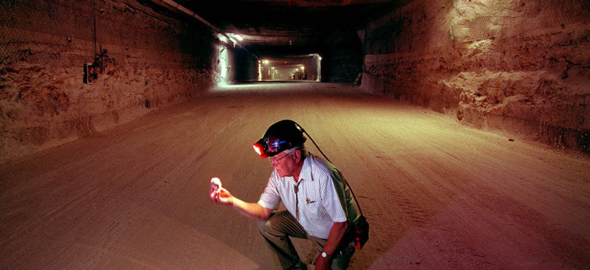 Sandia National Laboratories Senior Fellow Wendell Weart examines a salt crystal from the floor of one of the deep underground salt chambers excavated for transuranic nuclear waste storage at the Waste Isolation Pilot Plant east of Carlsbad, N.M. 