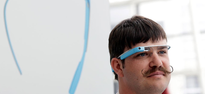 Engineer Ian McKellar wears a pair of Google Glass at a booth at Google I/O 2013 in San Francisco.