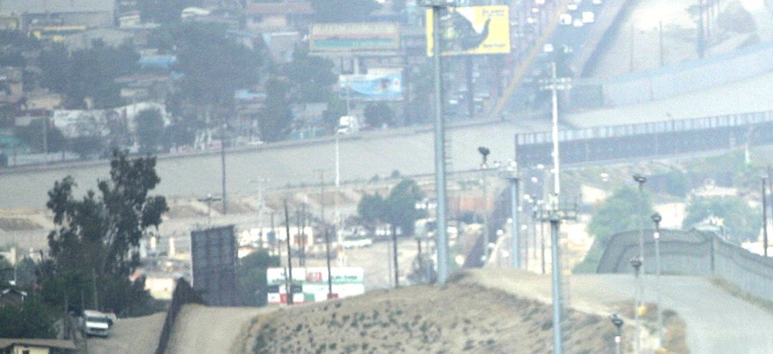 A lone Border Patrol vehicle along with tower mounted video cameras monitor activity along the border fence between Tijuana and San Diego.