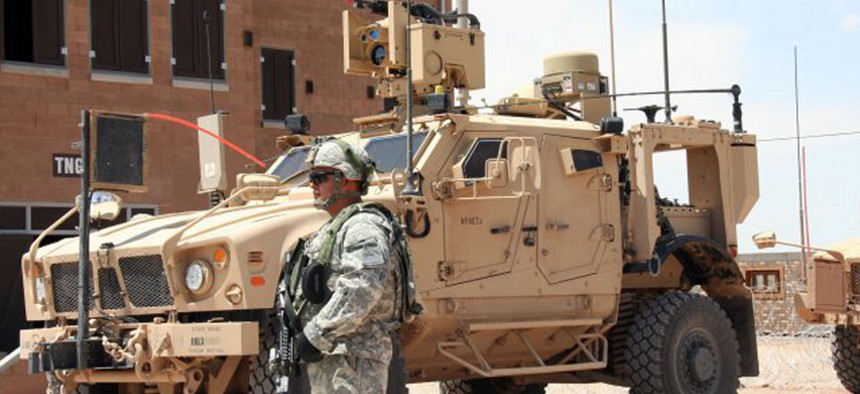 A Soldier from 2nd Brigade, 1st Armored Division, stands before a Warfighter Information Network-Tactical Increment 2 Point of Presence in May 2012.