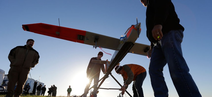 Texas A&M Corpus Christi researchers prepare a unmanned aircraft system for testing at a ranch near Sarita, Texas.