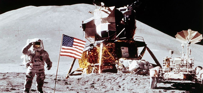 Apollo 15 Lunar Module Pilot James B. Irwin salutes while standing beside the fourth American flag planted on the surface of the moon, July 30, 1971. 