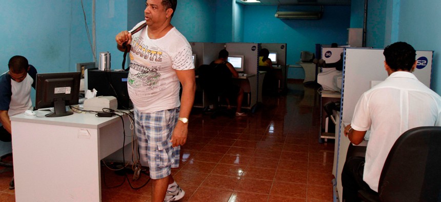 A man leaves a state-run computer center in Havana in 2012.