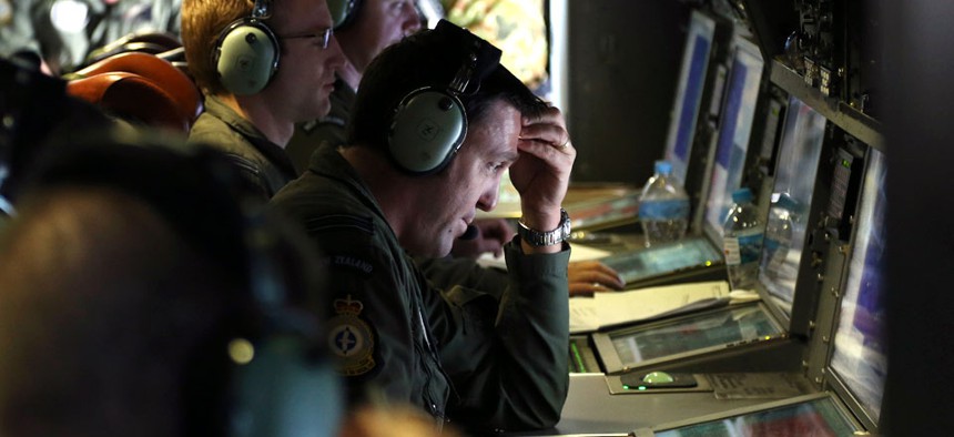 Operators monitors TAC stations onboard a Royal New Zealand Air Force P3 Orion during search operations for wreckage and debris of missing Malaysia Airlines Flight MH370 in the southern Indian Ocean.