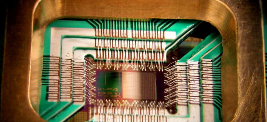 A chip constructed by D-Wave Systems Inc. designed to operate as a 128-qubit superconducting adiabatic quantum optimization processor, mounted in a sample holder.