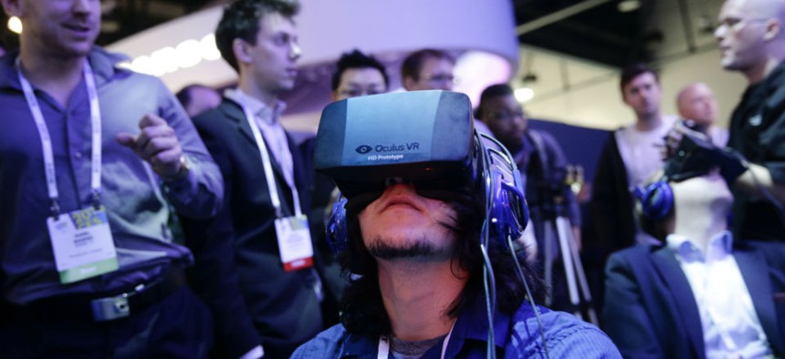 Attendees play a video game wearing Oculus Rift virtual reality headsets at the Intel booth at the International Consumer Electronics Show in Las Vegas.