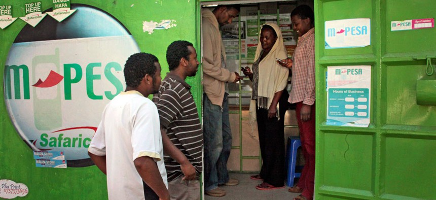 Customers make money transfers at an M-Pesa counter in Nairobi, Kenya.