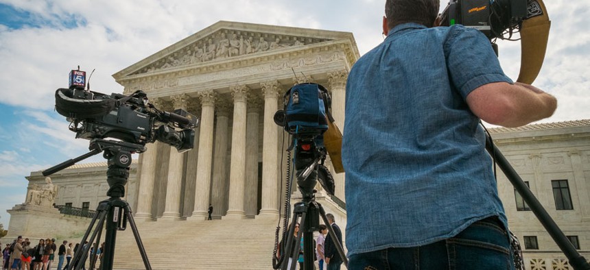 Videojournalists set up outside of the U.S. Supreme Court in Washington, Tuesday, April 22, 2104.