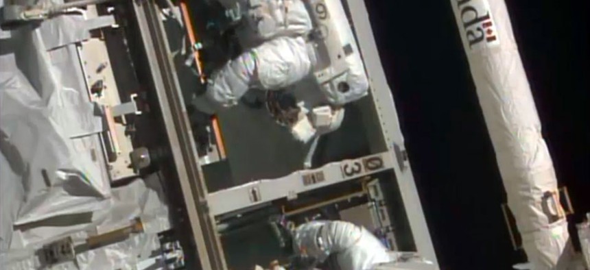 NASA astronauts Steven Swanson, left, and Rick Mastracchio perform a spacewalk outside the International Space Station.