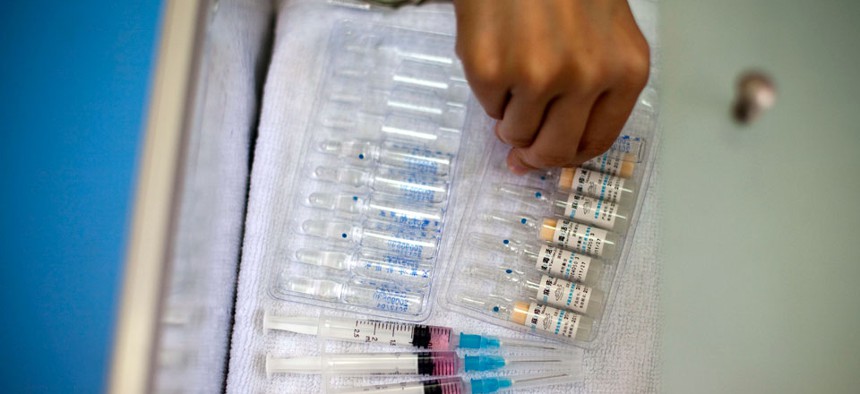 A nurse prepares vaccine shots against measles at a clinic in Beijing, China.