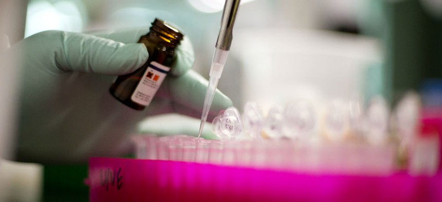 Microbiologist Ashley Sabol extracts Listeria bacteria for genome sequencing in a foodborne disease outbreak lab at the federal Centers for Disease Control and Prevention.