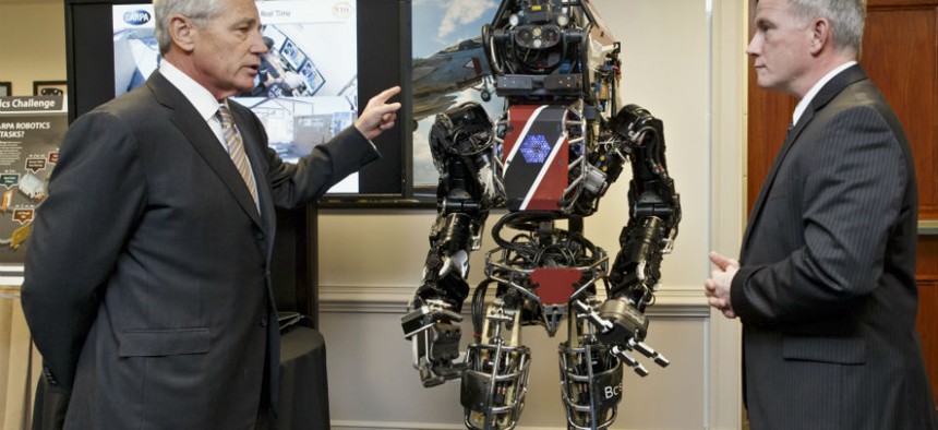 Defense Secretary Chuck Hagel gets a look at one of the latest robotics projects from DARPA