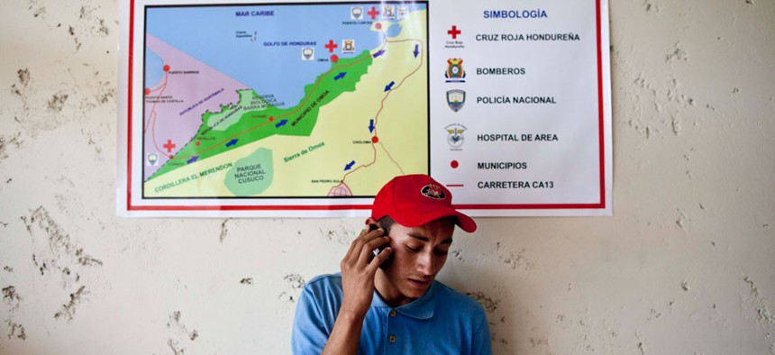 A man talks on a cell phone in Corinto, Honduras, near the border with Guatemala. 