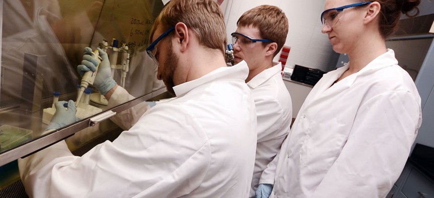 Biology and chemistry graduate students work in a lab at the university in Sioux Falls, SD.